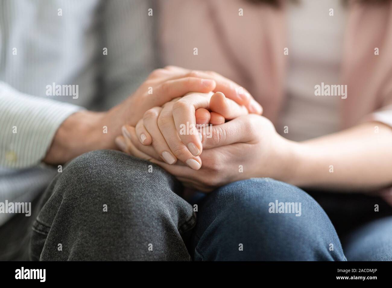 Man and woman holding each other hands, giving psychological support Stock Photo