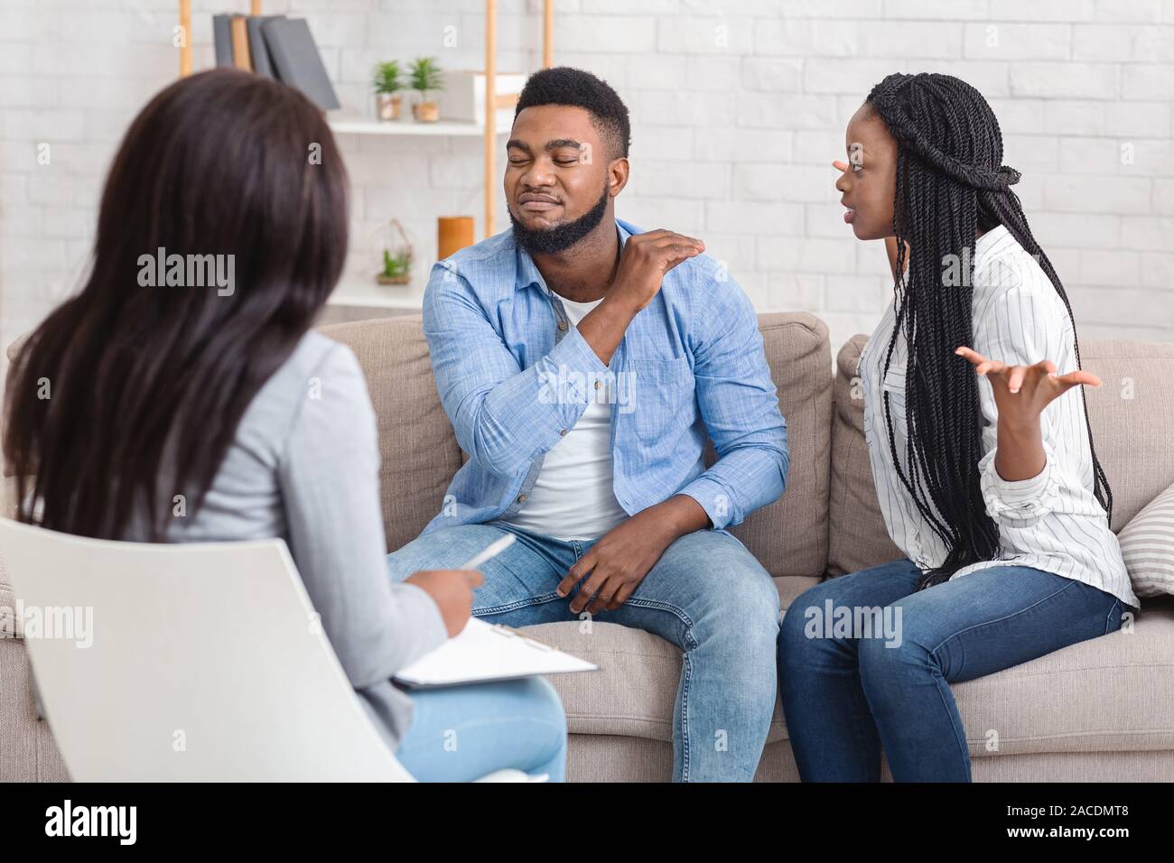 Black Couple Arguing During Marriage And Family Therapy Counselling Session Stock Photo