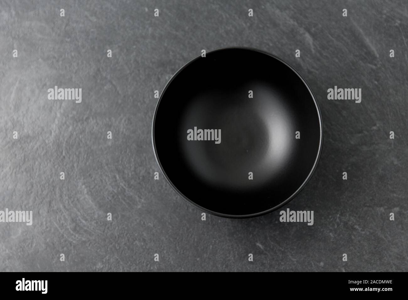 black ceramic plate on slate background Stock Photo