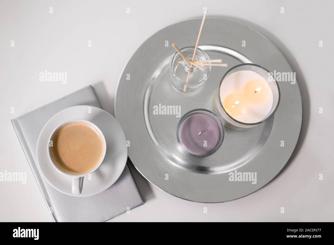 coffee, candles and aroma reed diffuser on table Stock Photo