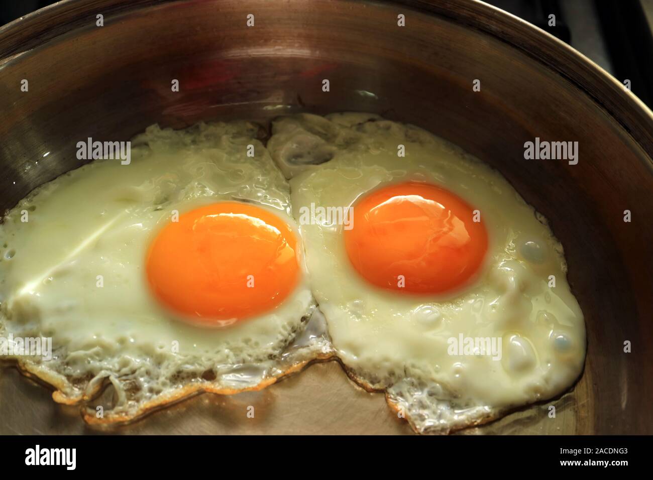Two Delectable Sunny Side Up Eggs in a Frying Pan Stock Photo