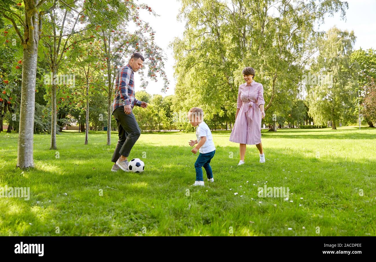 happy family playing soccer at summer park Stock Photo - Alamy