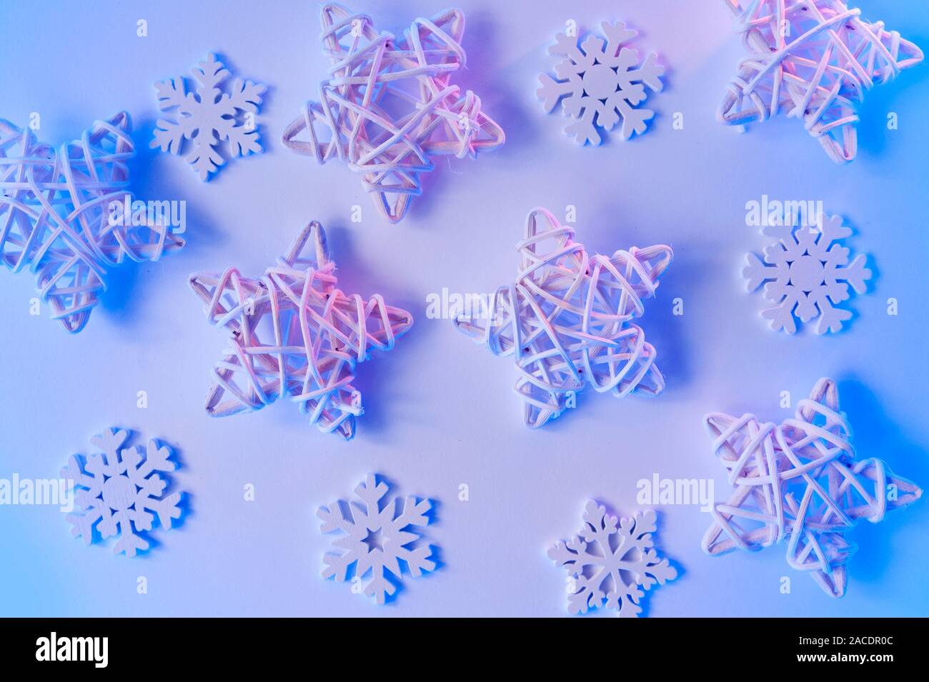 Christmas blue neon background with wooden stars and snowflakes. Holiday greeting card design with gradient lights Stock Photo
