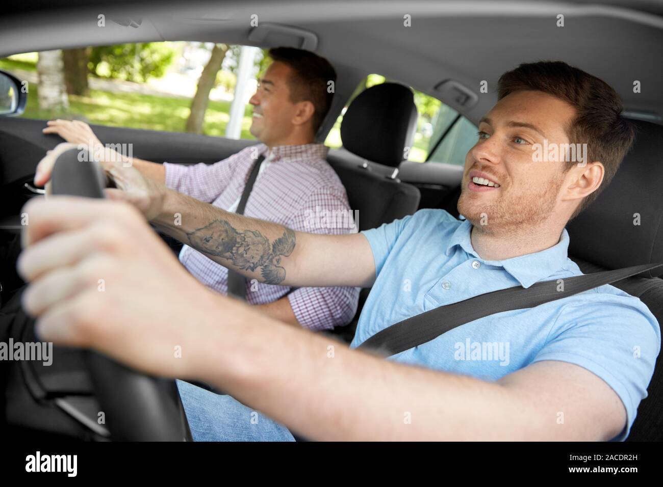 car driving school instructor and male driver Stock Photo - Alamy
