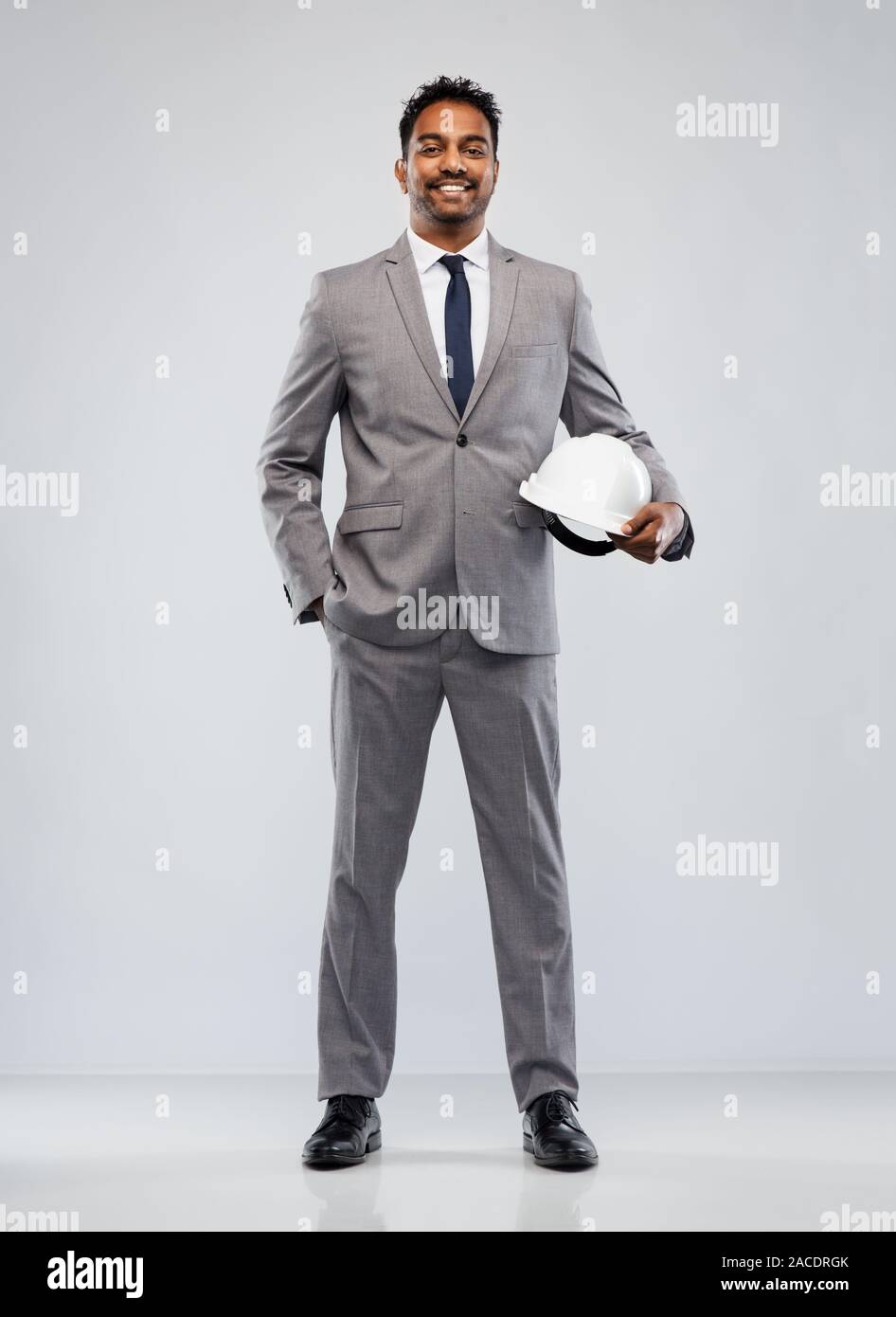 indian male architect with helmet over grey Stock Photo