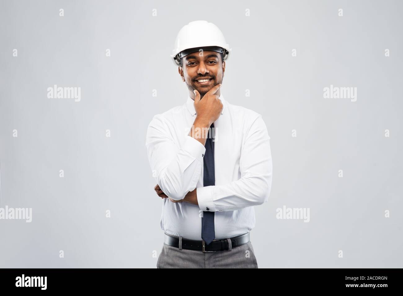 indian male architect in helmet over grey Stock Photo