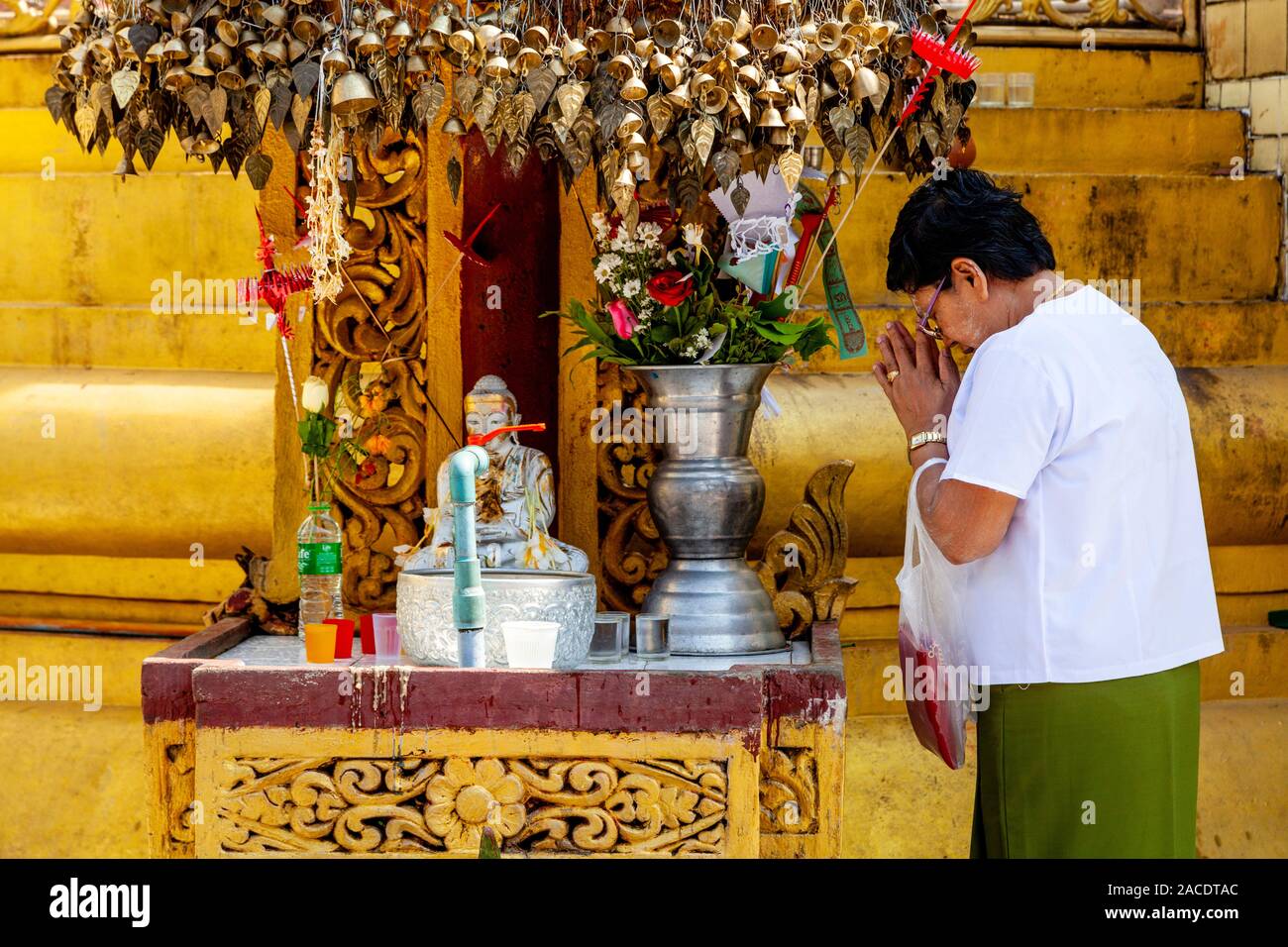 A Buddhist Woman Praying At The Sule Pagoda, Yangon, Myanmar. Stock Photo