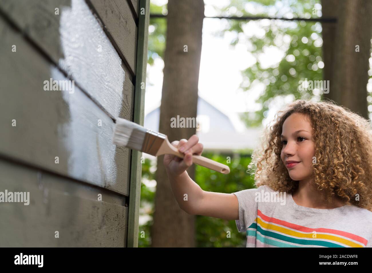 Girl painting house Stock Photo