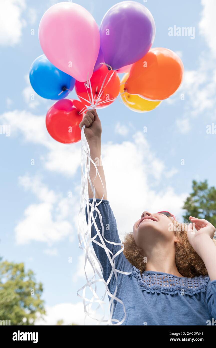 Girl holding balloons Stock Photo Alamy
