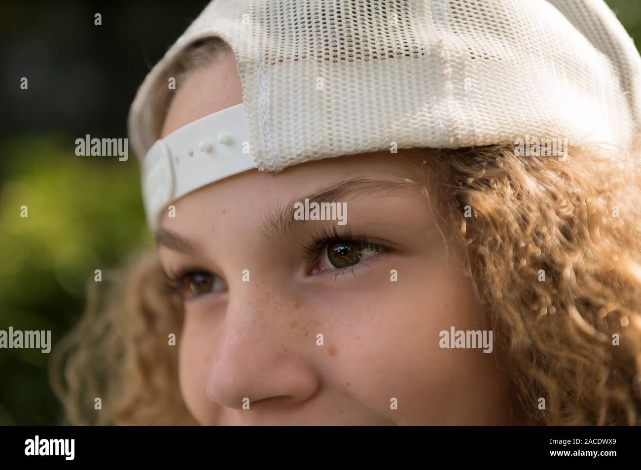 Close up of girl wearing baseball cap Stock Photo