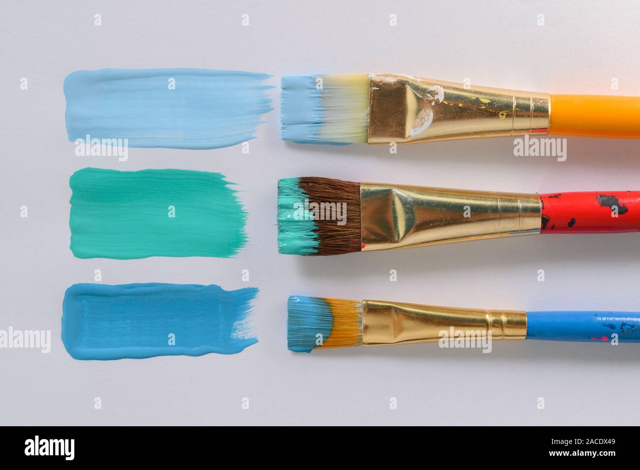 Paintbrushes and blue brushstrokes Stock Photo