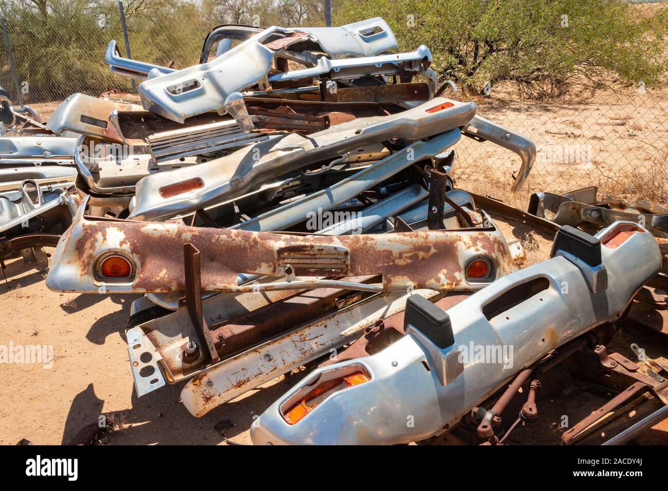 chrome fenders bumpers in a junk yard in the desert near Phoenix Arizona USA Stock Photo