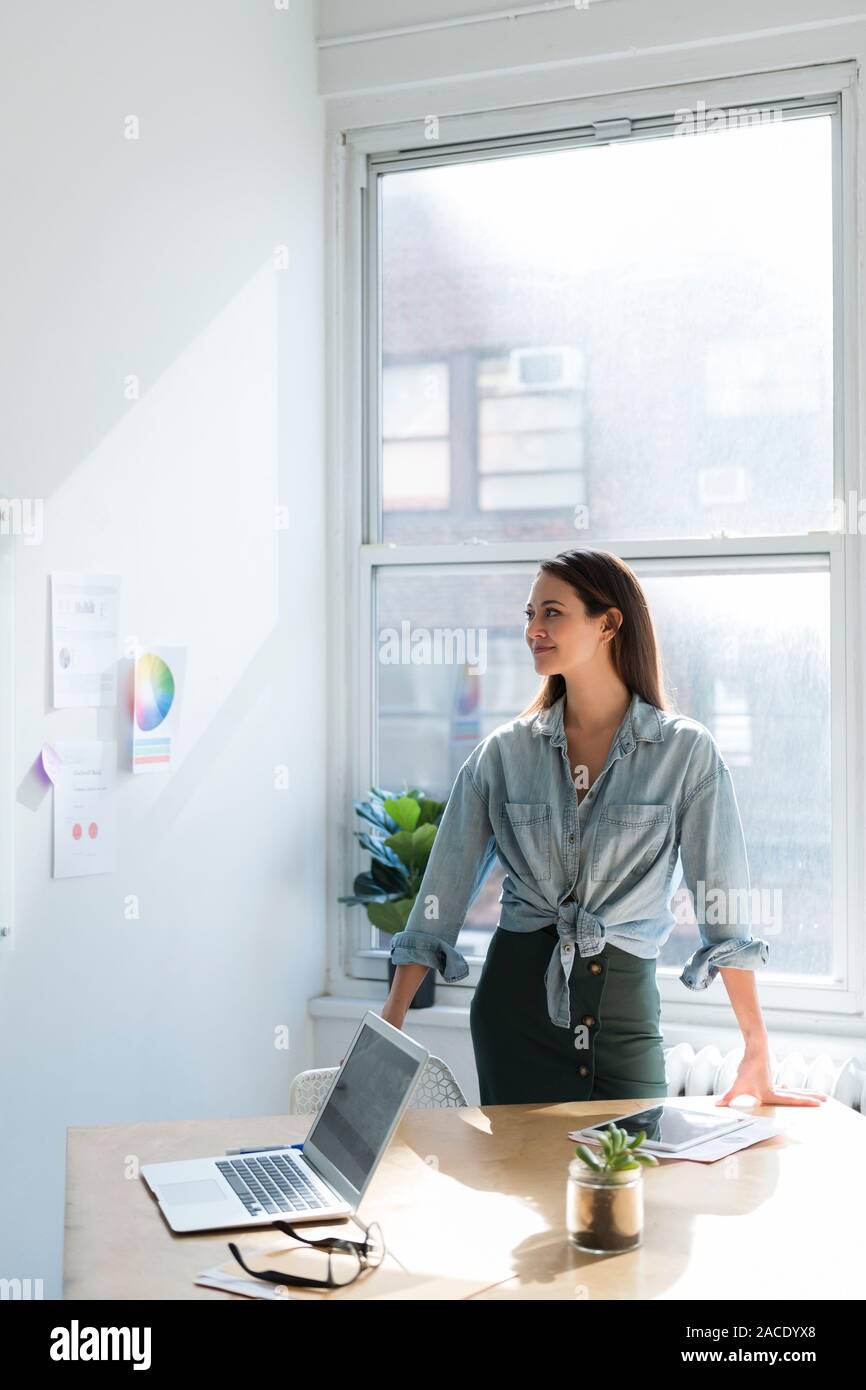 Business woman standing behind office desk Stock Photo