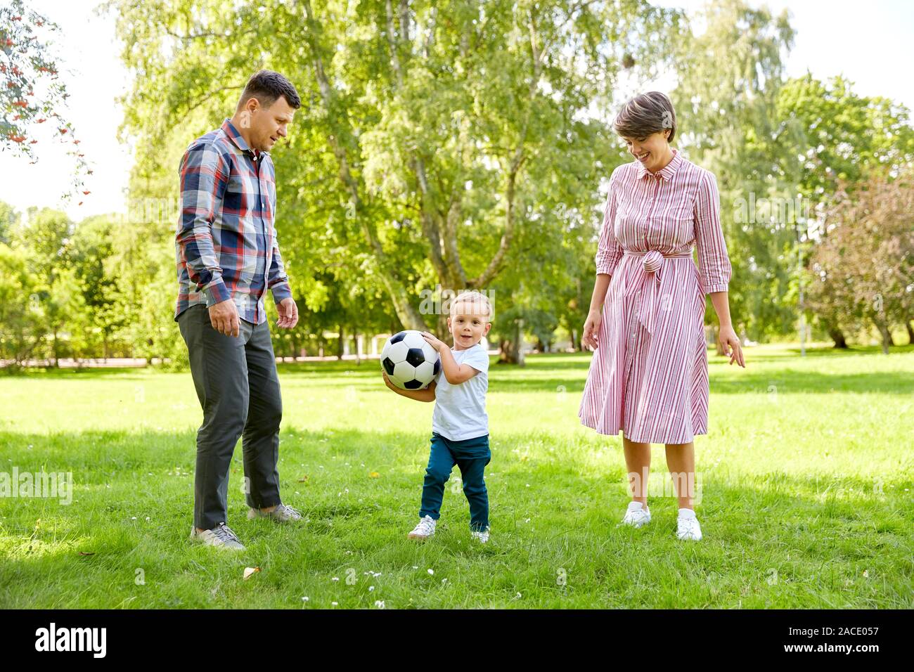 happy family playing soccer at summer park Stock Photo - Alamy