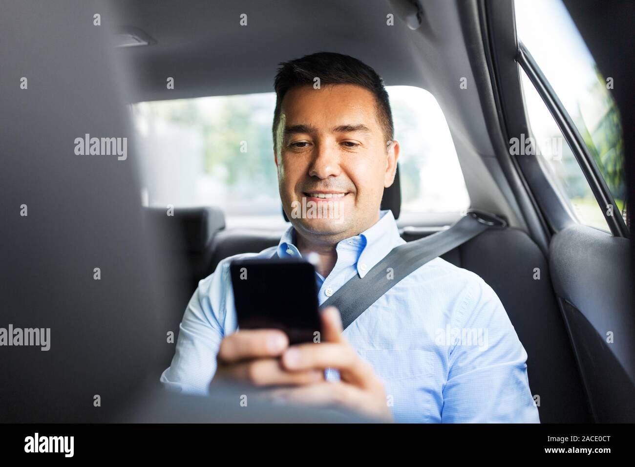passenger or businessman using smartphone in car Stock Photo Alamy