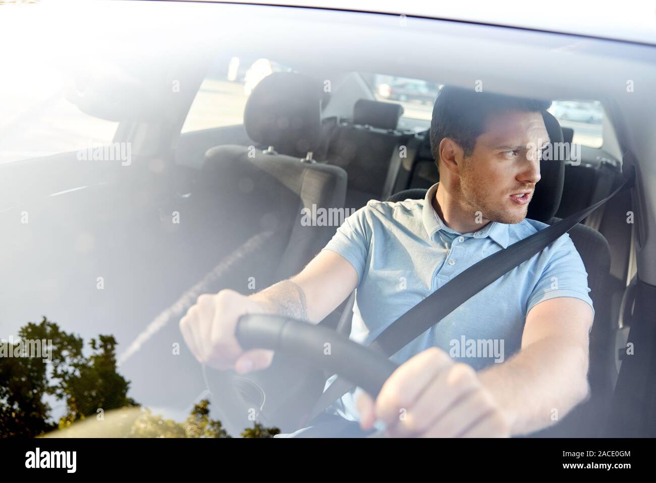 displeased young man or driver driving car Stock Photo