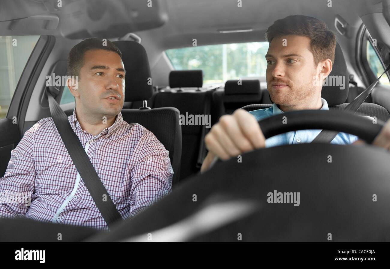 car driving school instructor and male driver Stock Photo