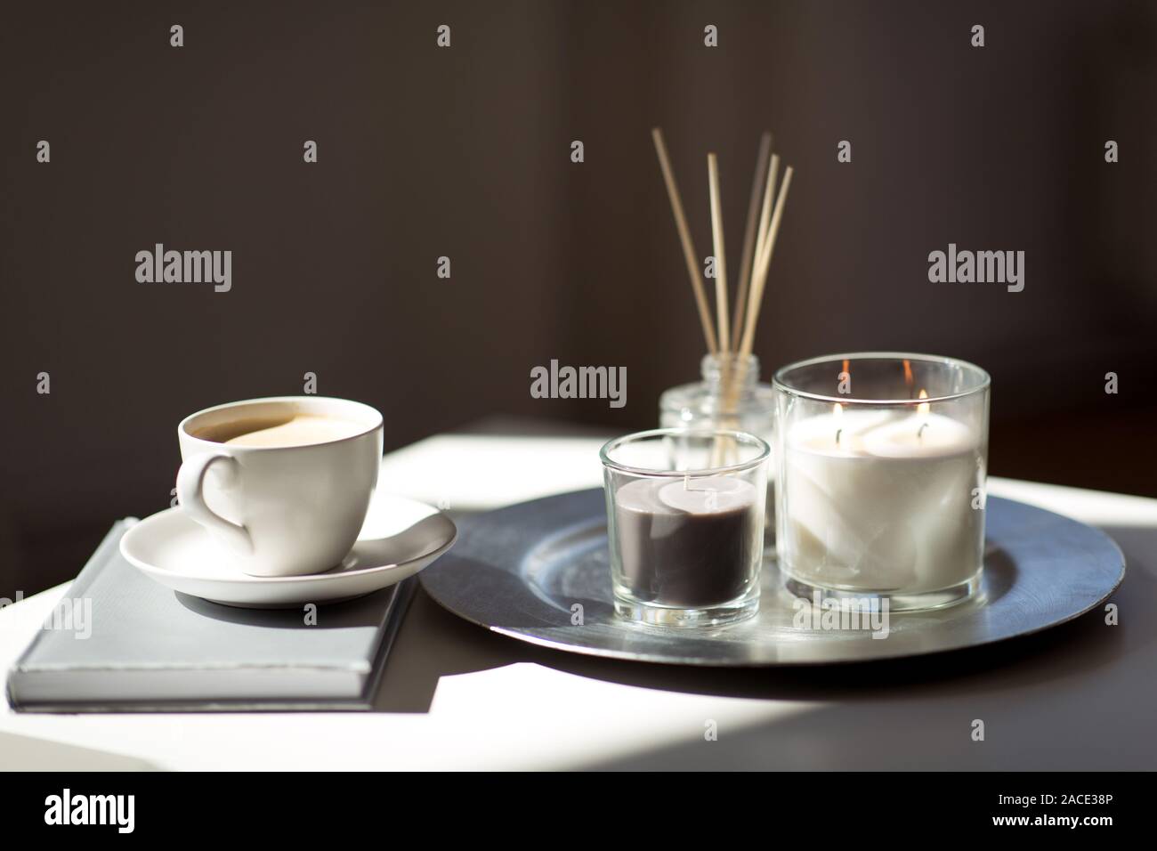 coffee, candles and aroma reed diffuser on table Stock Photo