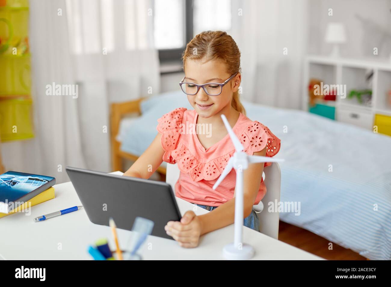 student girl with tablet pc and wind turbine model Stock Photo