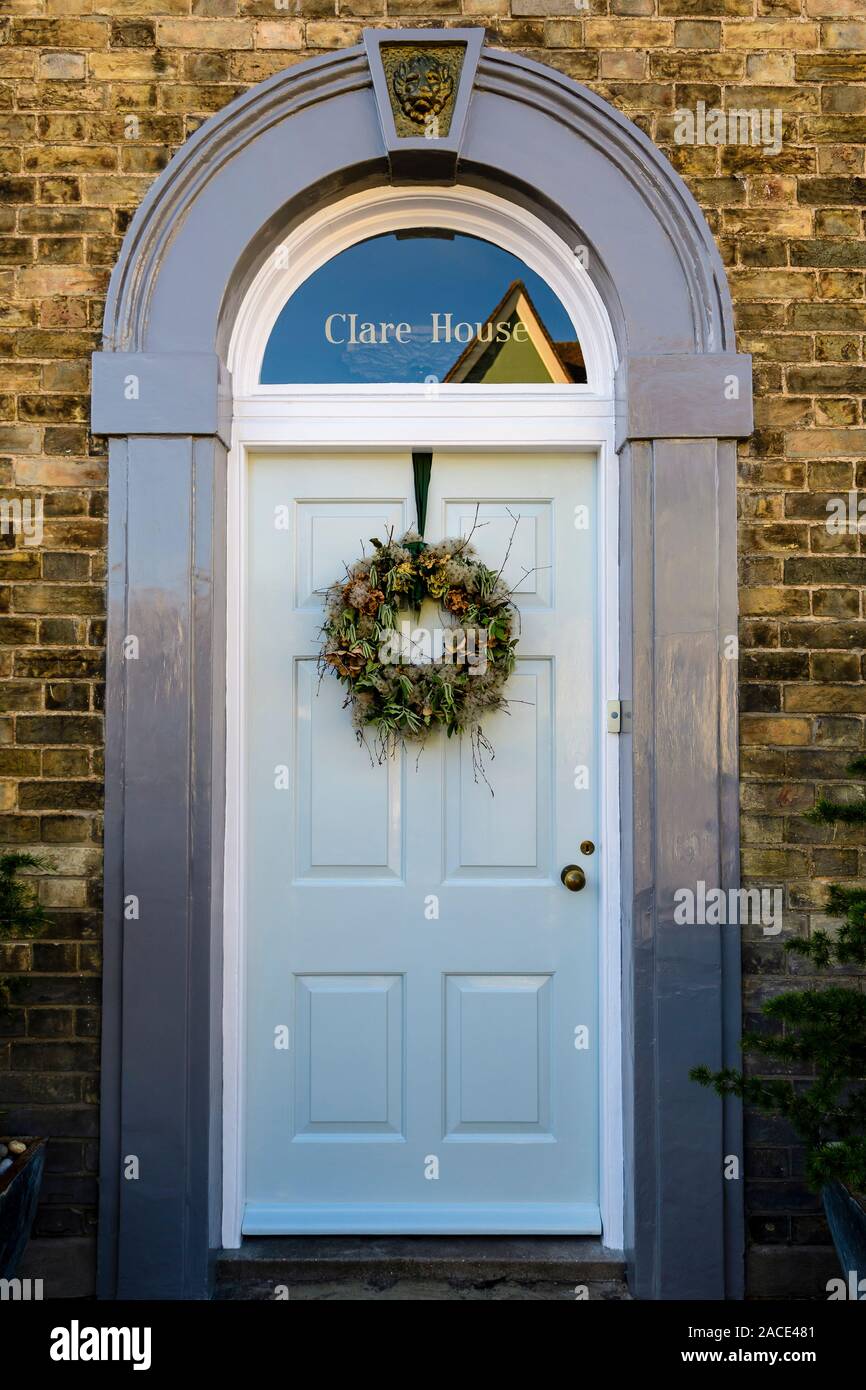 A Decorative Winter Wreath Hanging On A Front Door In The