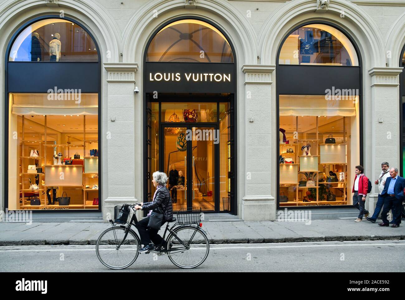 Exterior of the Louis Vuitton high-fashion store in the historic centre of  Florence with an old lady passing by bike, Tuscany, Italy Stock Photo -  Alamy