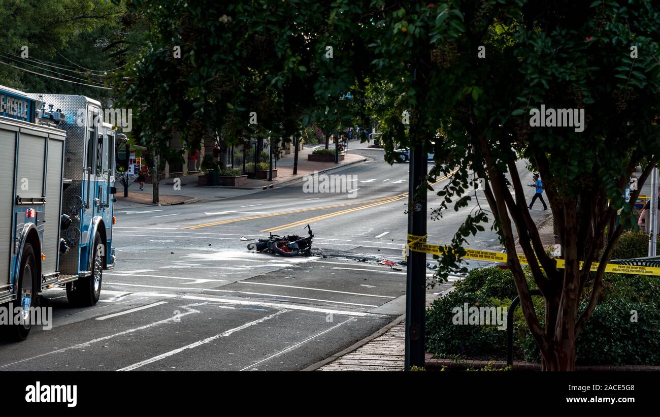 Wrecked motorcyle in front of firetruck and laying on the road after exploding in accident in
