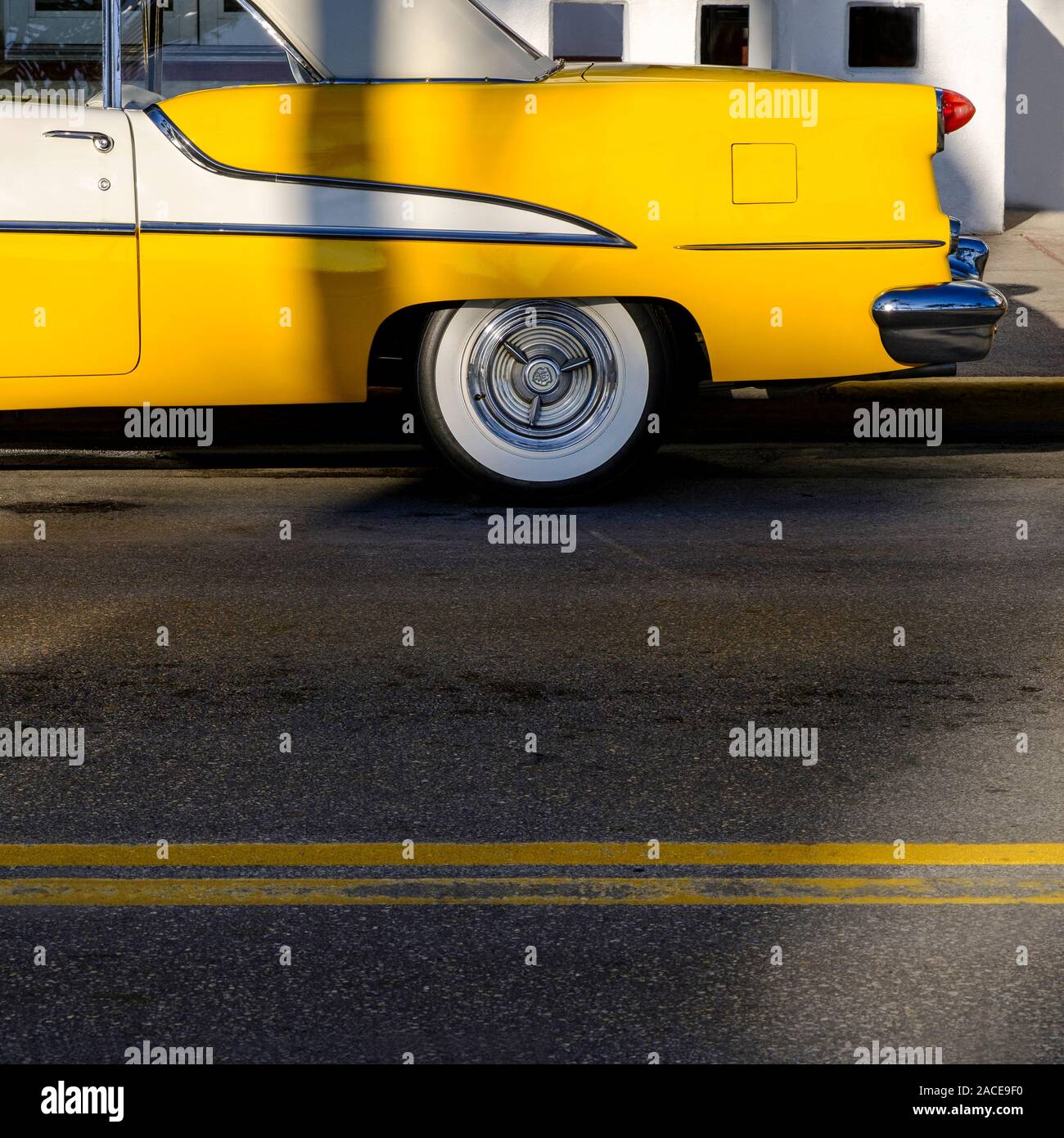 Yellow old fashioned car on road Stock Photo