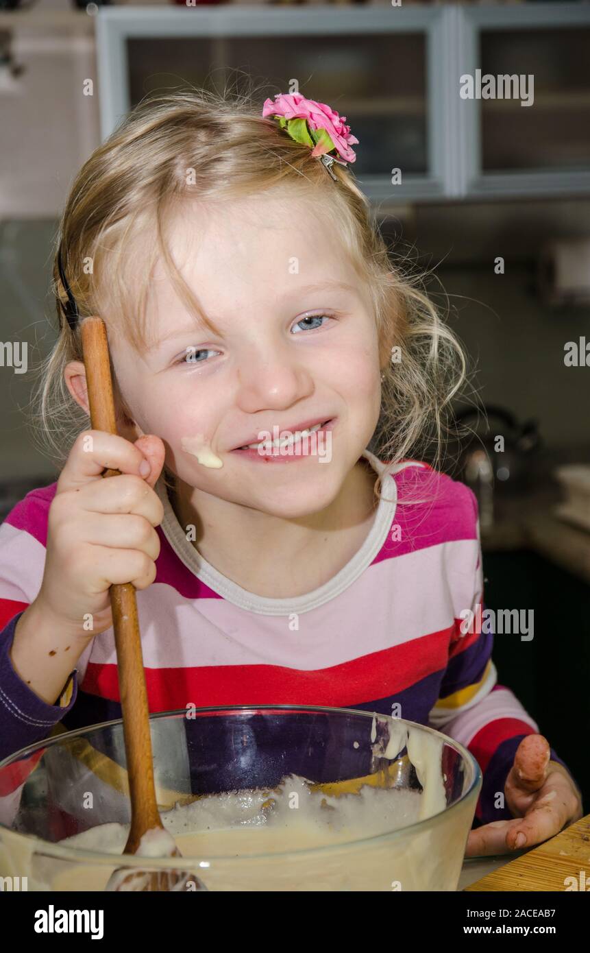 girl shaking dough with the ladle Stock Photo Alamy
