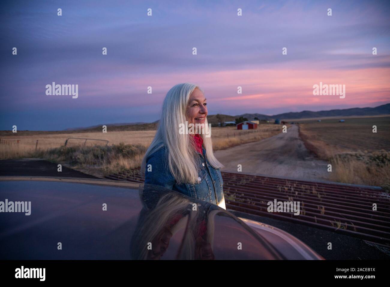 Woman behind car at sunset in Boise, Idaho, USA Stock Photo