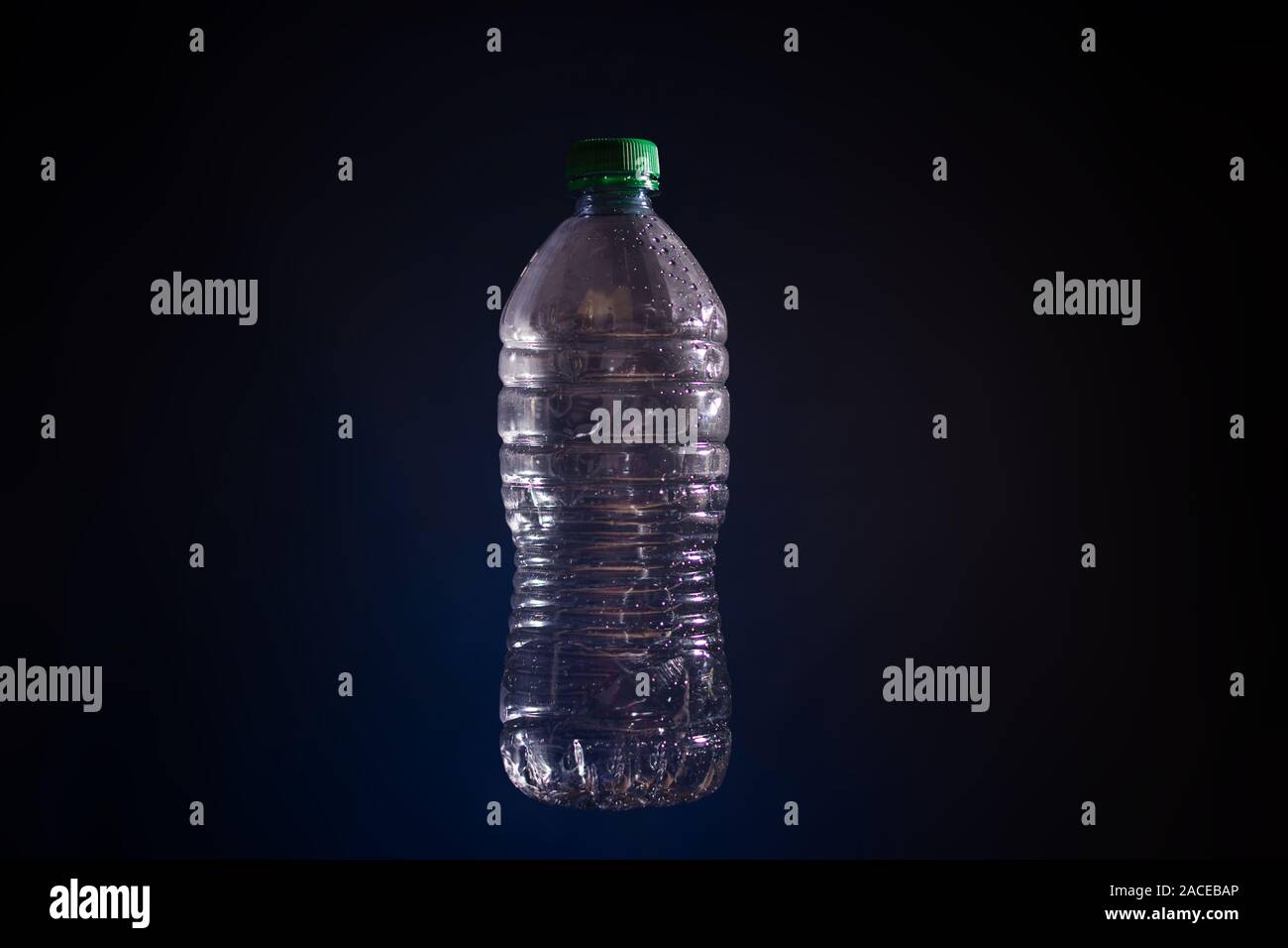 Silhouette of transparent plastic bottle used on dark background Stock Photo