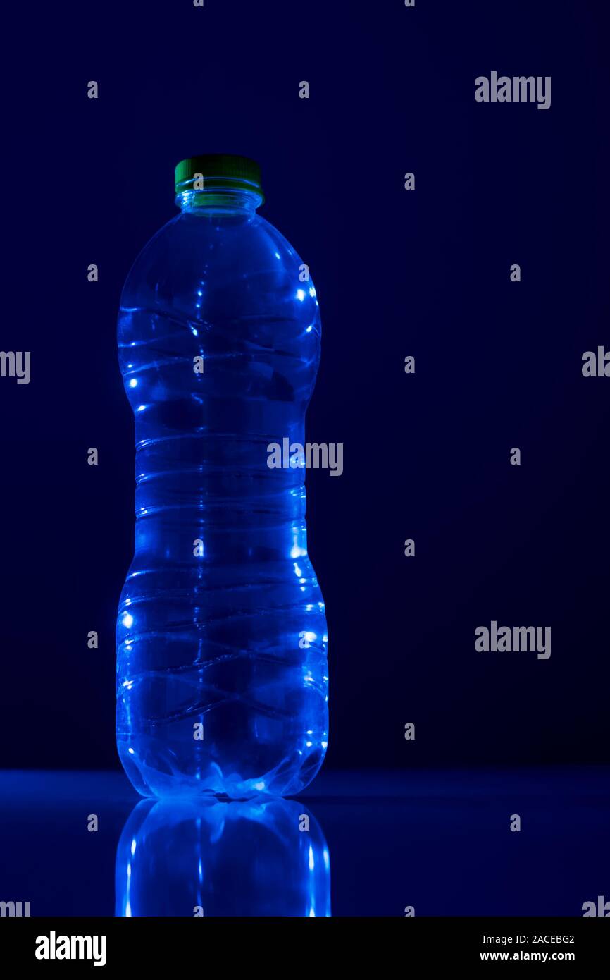 Empty plastic bottle in transparent PET on a blue background Stock Photo