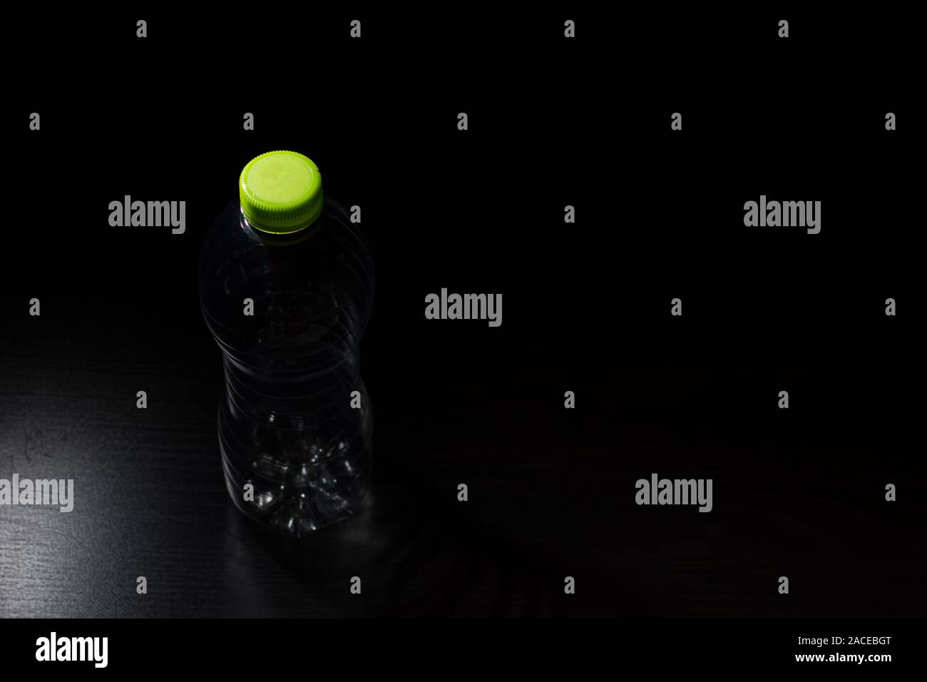 Empty plastic bottle in transparent PET on a black background Stock Photo