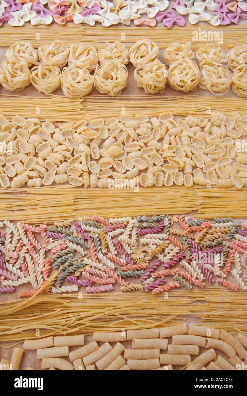 Assorted uncooked pasta in rows Stock Photo