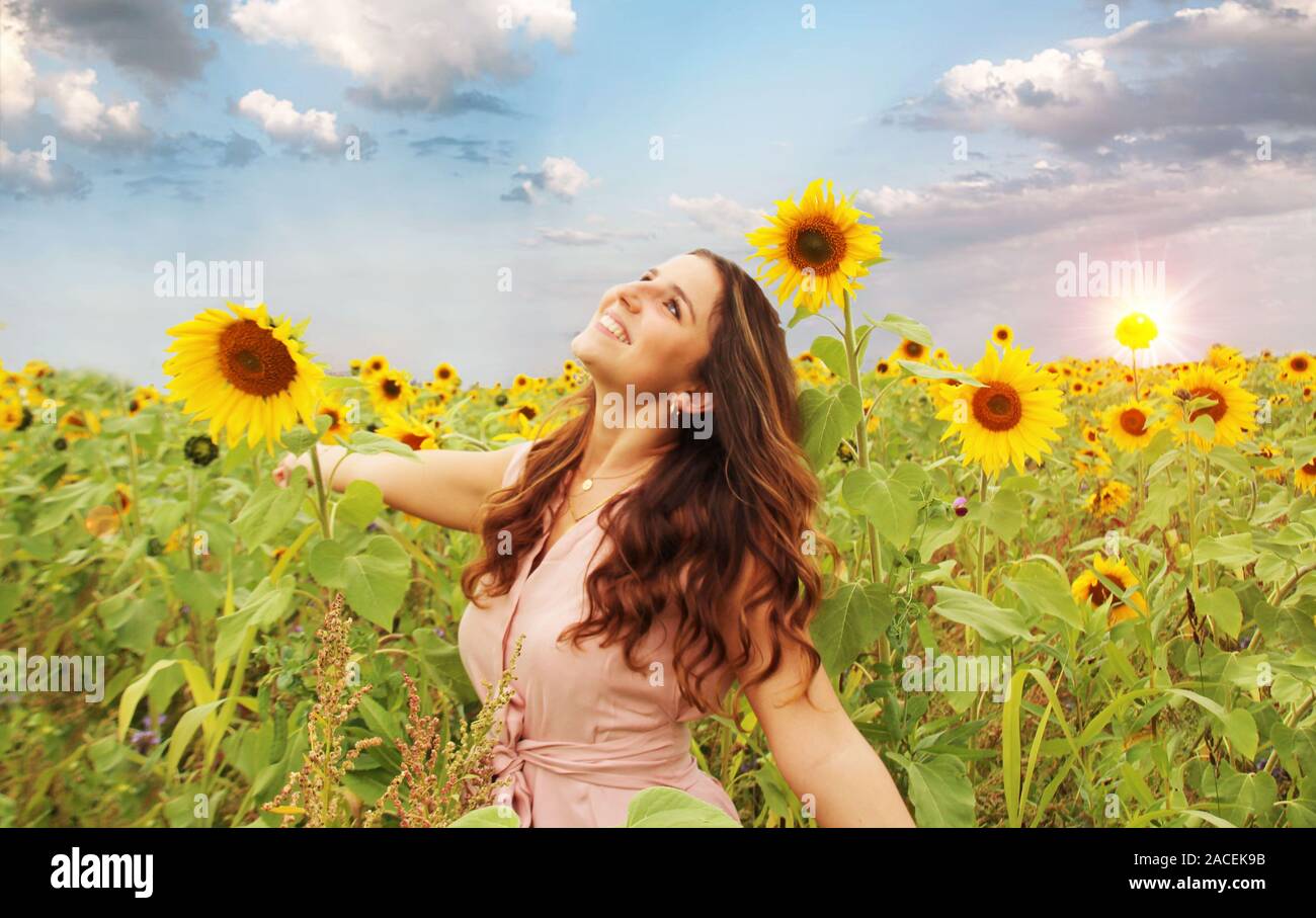Beautiful woman in a sunflower field Stock Photo - Alamy