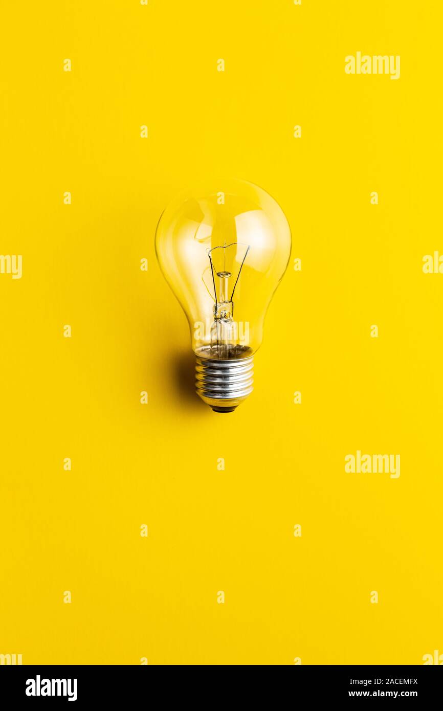 Classic light bulb on yellow background. Stock Photo