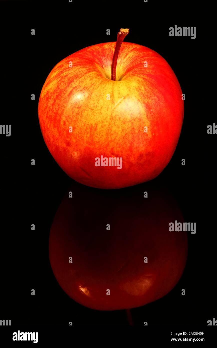 Red eating apple isolated on black glass with a reflection Stock Photo