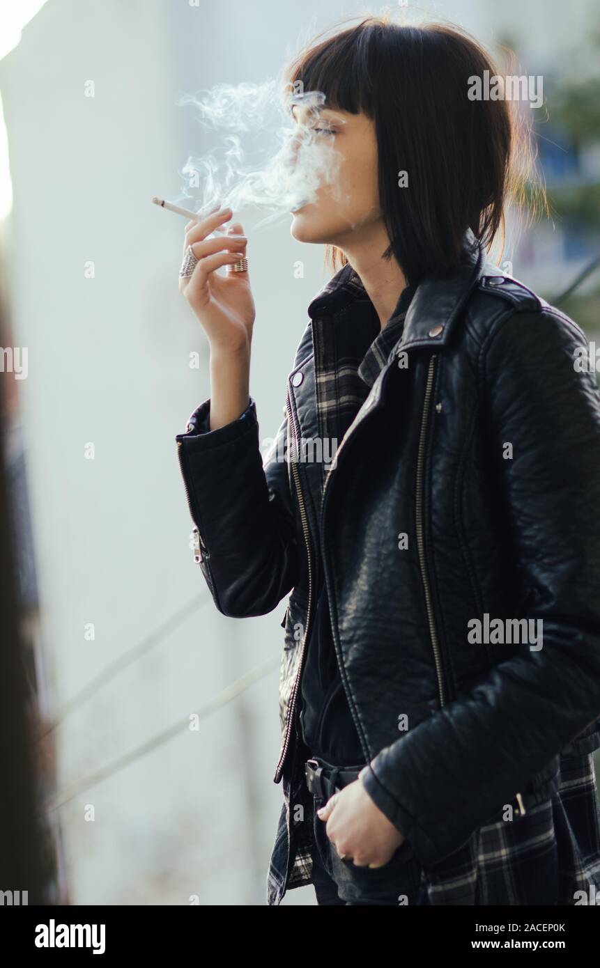 Young girl smoking with cloud puff smoke of face Stock Photo