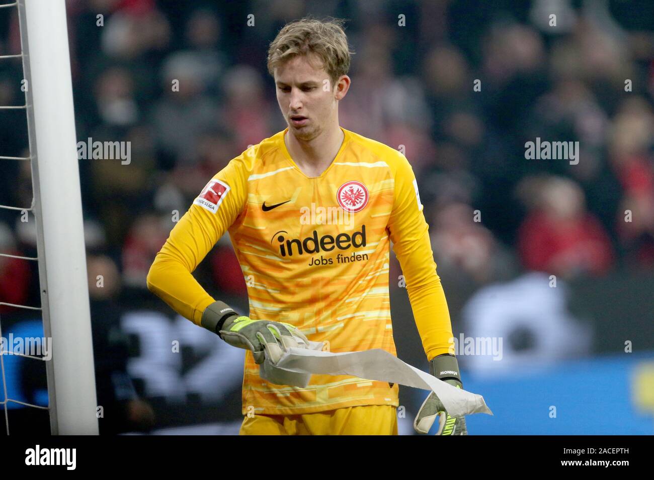 Mainz, Germany. 02nd Dec, 2019. Soccer: Bundesliga, FSV Mainz 05 - Eintracht Frankfurt, 13th matchday in the Opel Arena. Frankfurt goalkeeper Frederik Rönnow throws a roll of toilet paper off the field. Credit: Thomas Frey/dpa - IMPORTANT NOTE: In accordance with the requirements of the DFL Deutsche Fußball Liga or the DFB Deutscher Fußball-Bund, it is prohibited to use or have used photographs taken in the stadium and/or the match in the form of sequence images and/or video-like photo sequences./dpa/Alamy Live News Stock Photo