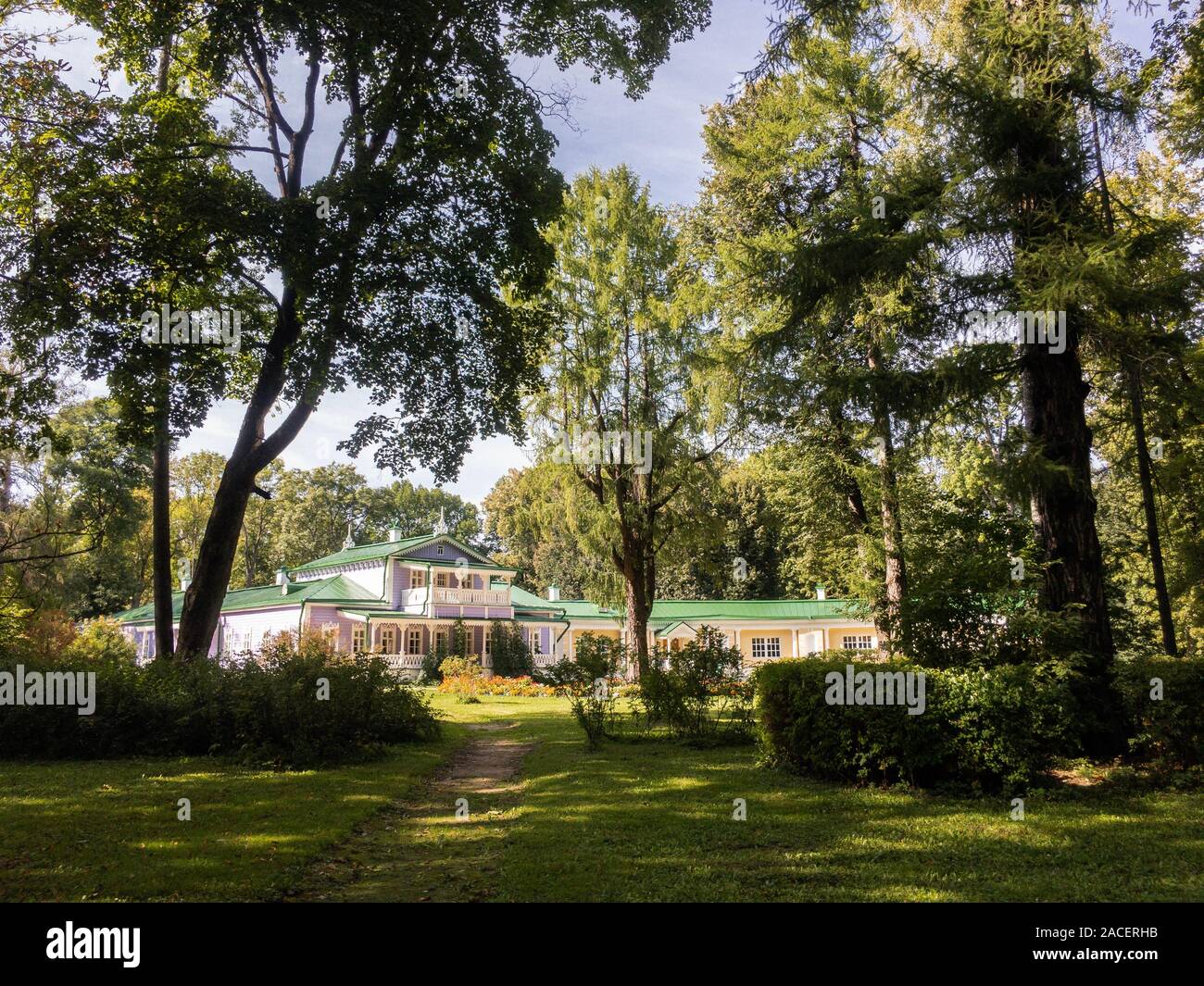 Spasskoe-Lutovinovo, Turgenev's estate behind high trees in sunny summer day horizontal Stock Photo