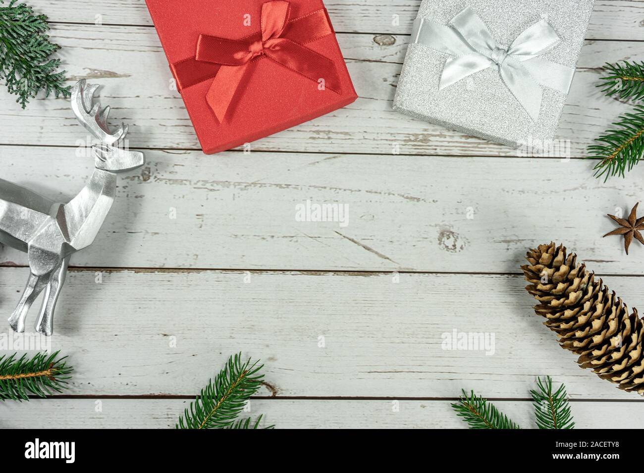 Christmas frame background flat lay on white wood with gift box and other natural decoration . Stock Photo