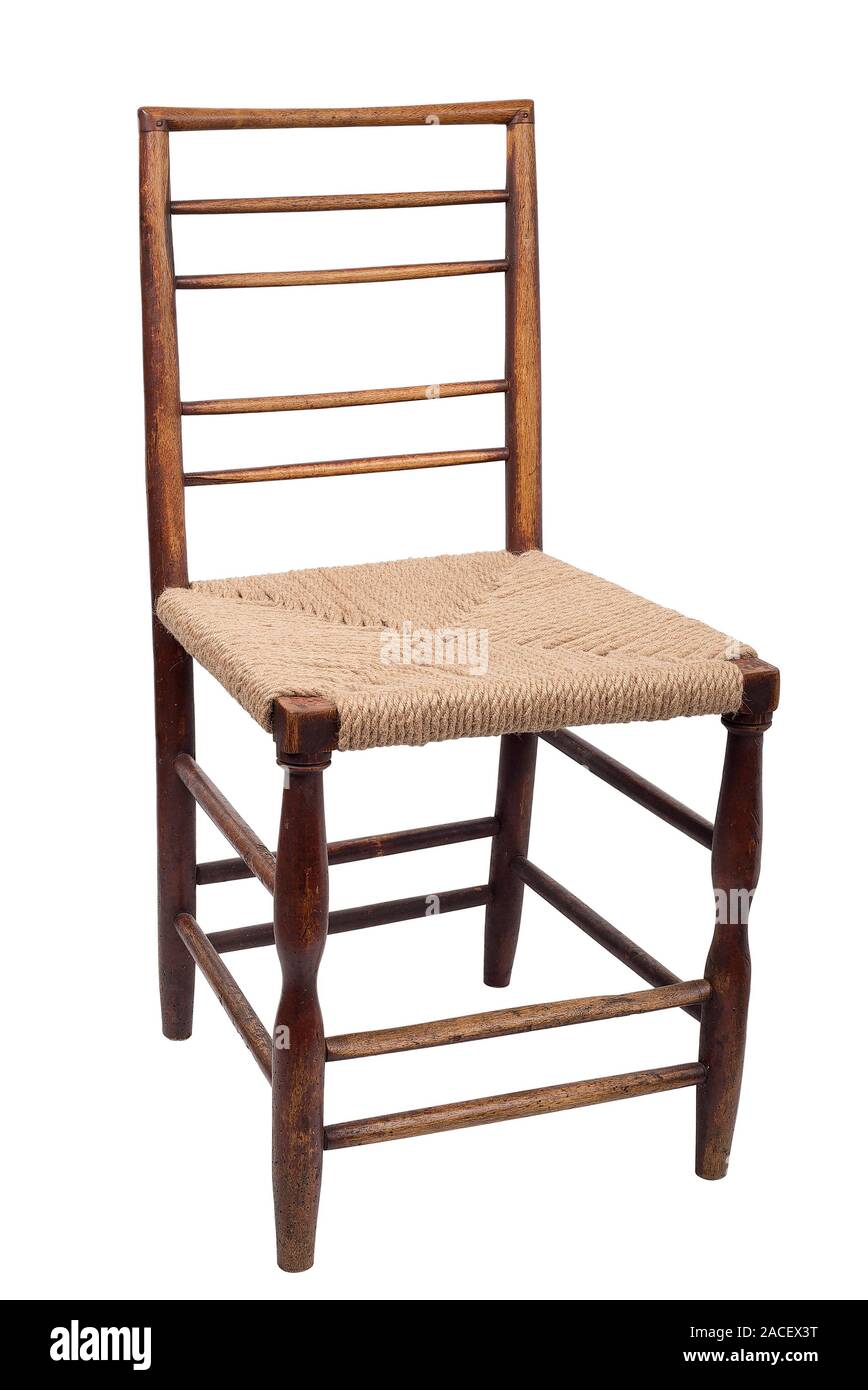 Wooden dining chair , a crisscross back and against wicker woven seat Stock Photo