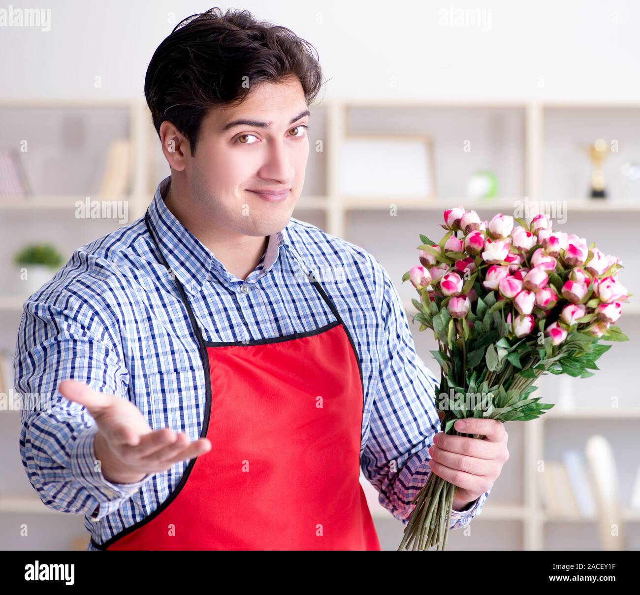 The flower shop assistant offering a bunch of flowers Stock Photo Alamy