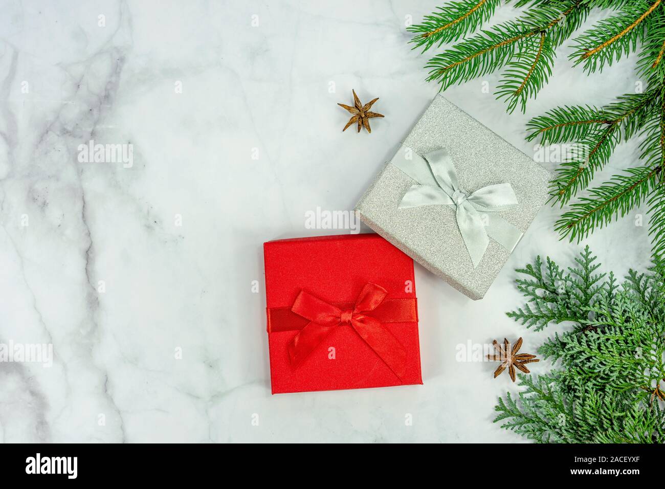 Christmas frame background on marbel with silver and red gift box . Stock Photo