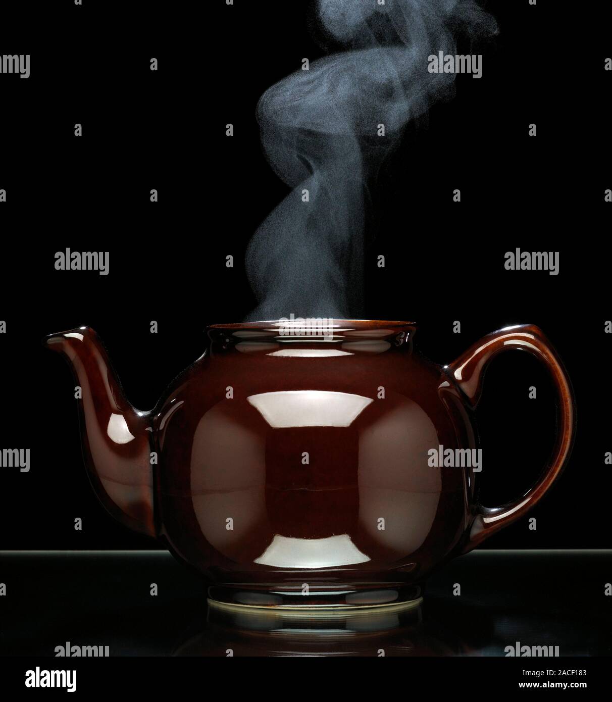 Teapot steaming. Teapot with steam coming out of the top from boiled