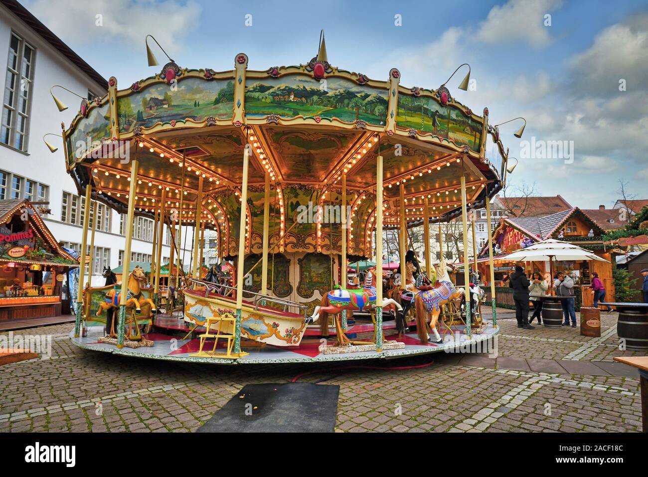 Antique carousel as part of traditional Christmas market at university square in Heidelberg city center Stock Photo