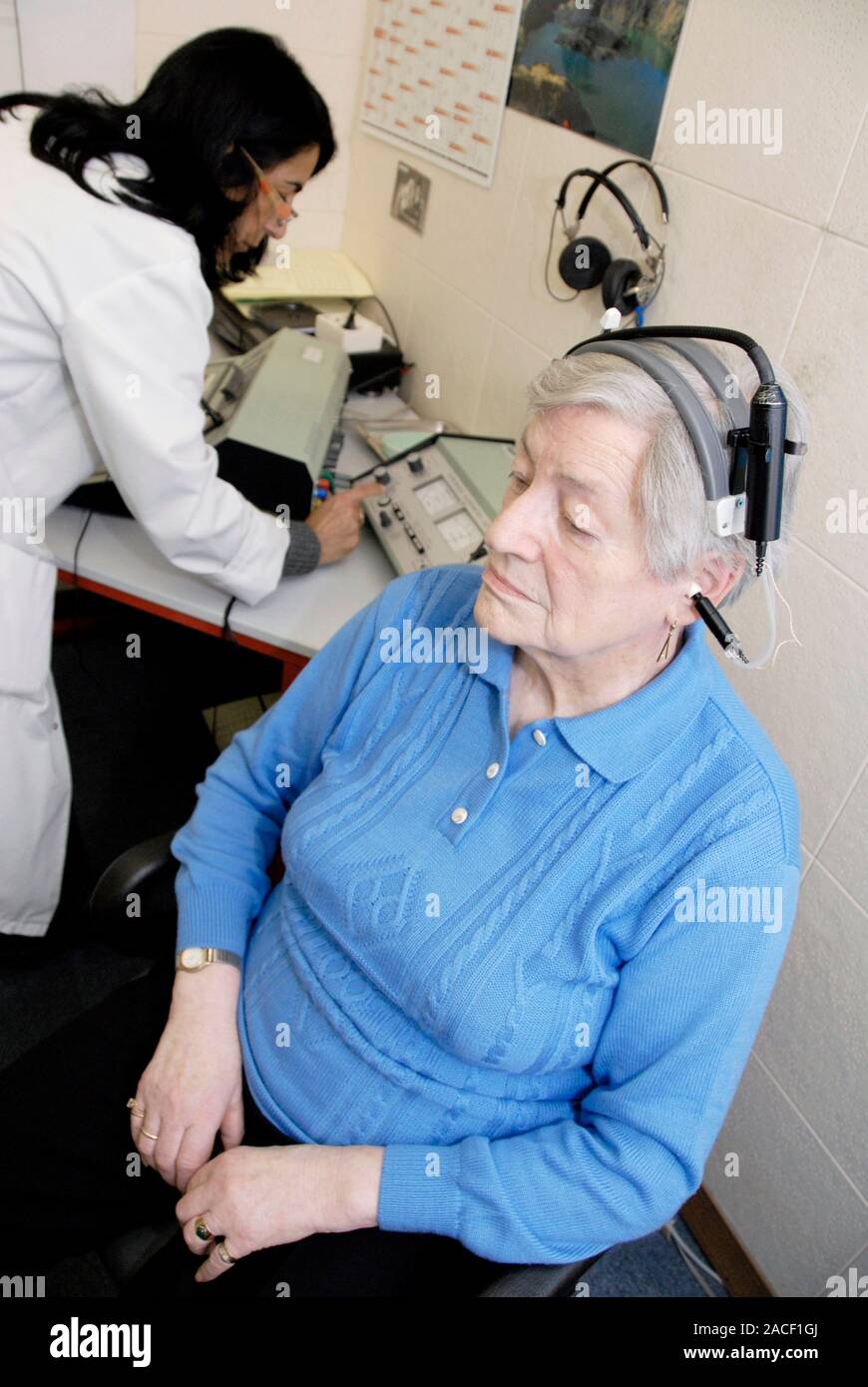 Tympanometry test. Audiometrist testing a patient's ear drum in a test ...