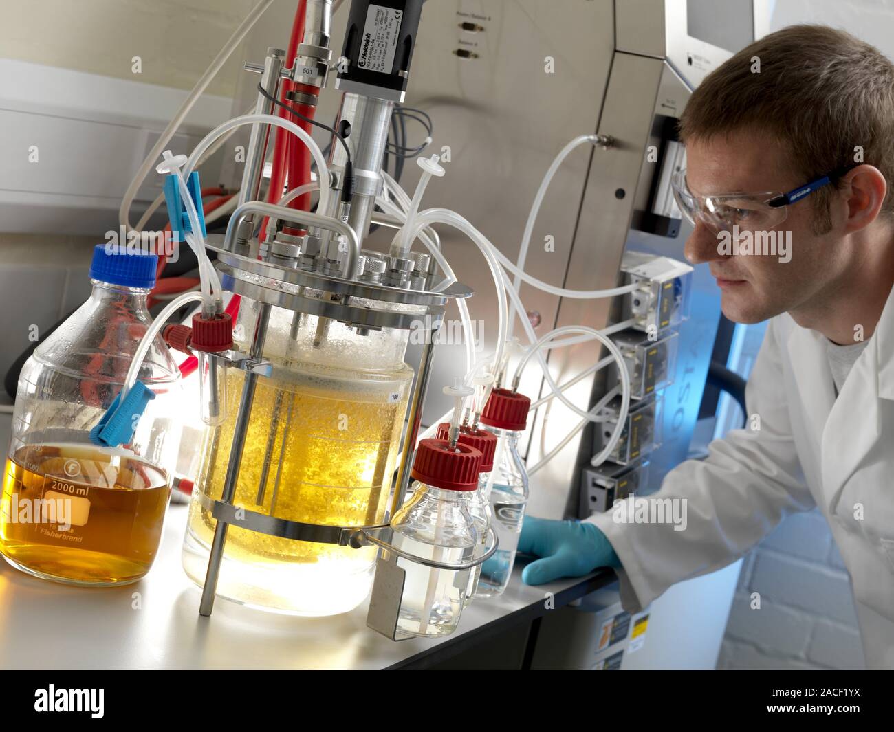 Bioreactor. Scientist with a smallscale bioreactor used for cell