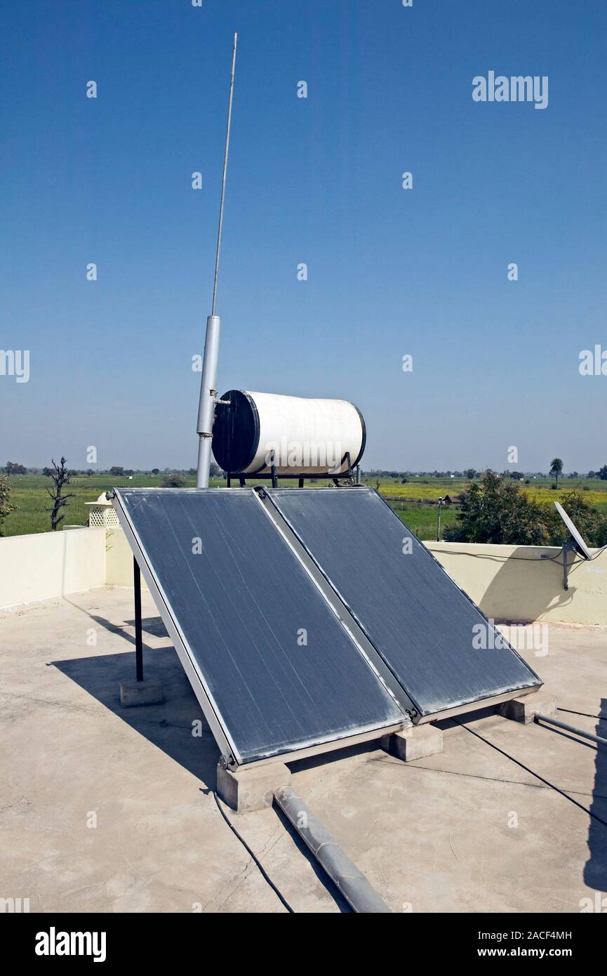 Solar water heater on a rooftop. Solar panels connected to a water tank ...