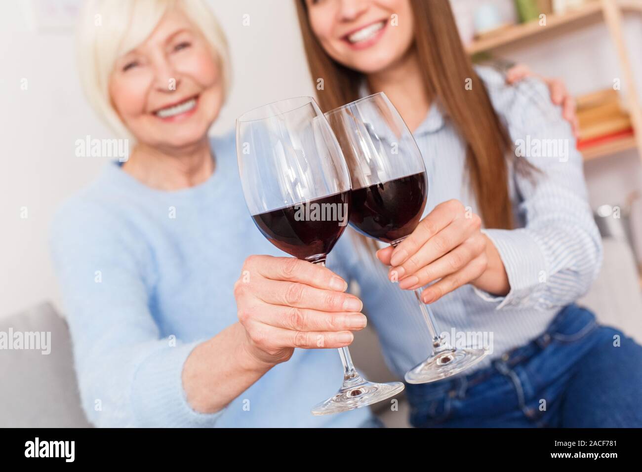 Toast of health! Old mother and daughter drinking wine Stock Photo