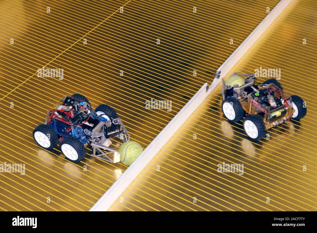 Toy robot vehicles using their pincers to pick up tennis balls